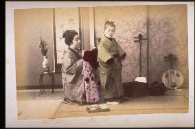 Mother dressing a child in her best clothes
