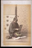 Merchant holding soroban,an abacus