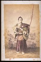 A samurai warrior ready to release an arrow from a bow