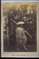 Laborer wearing mino,a straw raincoat