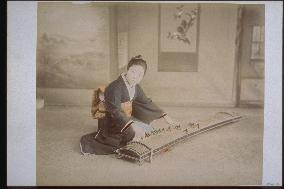 A woman playing the koto