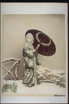 Woman in snow costume holding an umbrella