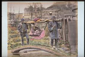 A woman in a basket palanquin