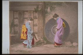 Woman putting up an umbrella with a bull's-eye design