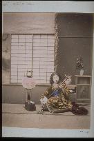 A woman playing the shamisen