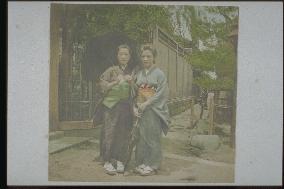 Two women holding western-style umbrellas