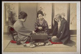 An old man and girls playing go