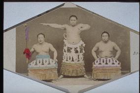 A sumo champion performing pre-match rituals