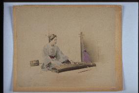 A woman playing the koto