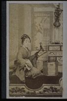 A woman playing the shamisen
