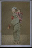 A woman carrying a child on her back