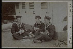 Sailors playing cards on their ship