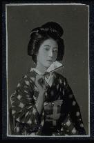 A woman holding a folding fan