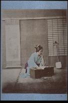 A woman reading a score for shamisen