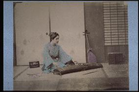 A woman playing the koto