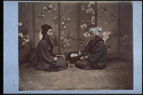 A girl and an old woman playing hanafuda