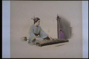 A woman playing the koto