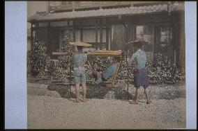 A palanquin bearer with a tattoo