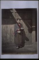 A girl holding a tea set