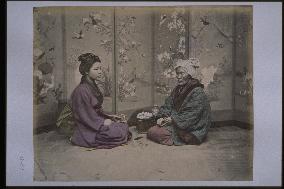 A girl and an old woman playing hanafuda