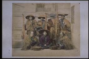 Farmers holding rope baskets,wearing straw raincoats and caps