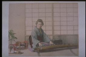 A woman playing the koto,and a tsuzumi (a small shoulder drum)