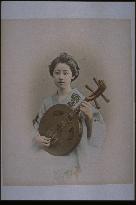 A woman playing the gekkin (an instrament of Chinese origin)