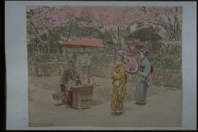 A candy seller and girls with sunshades