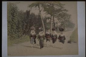 Women carrying luggage on their heads