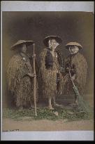 Farmers wearing straw raincoats and caps