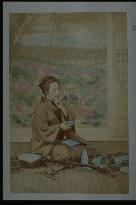 A woman drinking sake