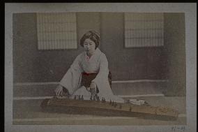 A woman playing the koto