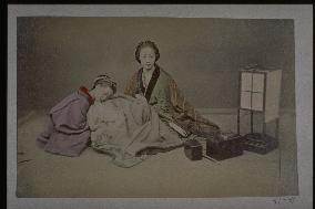 Women warming themselves at a kotatsu