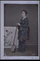 A woman holding a shamisen