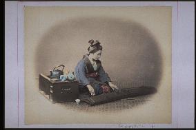A woman playing the koto,and a box brazier