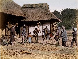Threshing at a farm house