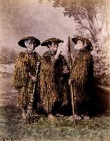 Farmers wearing straw raincoats and caps