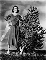 Actress FAITH DOMERGUE WITH CHRISTMAS TREE AND SAW