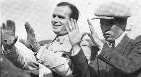 DOUGLAS FAIRBANKS AND CHARLIE CHAPLIN HOLD THEIR HANDS UP TO