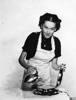 MAUREEN O'SULLIVAN MAKING WAFFLES WITH AN ELECTRIC WAFFLEMAK