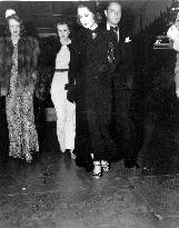 Norma Shearer looking at her hand and feet prints in the con