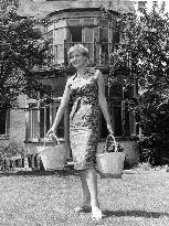 SYLVIA SYMS IN THE GARDEN OF HER NEW HOME IN THE MID NINETEE