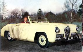 Actor MAXWELL REED with his new convertible Healy Special, 1