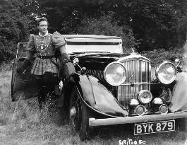 RICHARD TODD WITH HIS BENTLEY DURING THE FILMING OF THE SWOR