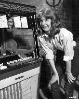 JANE ASHER listening to a juke box whilst making the film GI