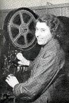 FEMALE PROJECTIONIST LACING UP A FILM DURING WORLD WAR 2