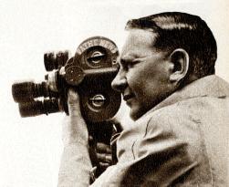 JOHN RUDKIN, British Pathe News cameraman with a Bell and Ho