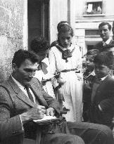 Actor JACK PALANCE signs autographs for some young fans whil