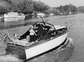 RONALD SHINER and his wife cruising down the river Thames