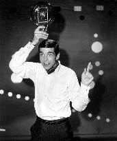 Actor TONY BILL clowning around with a powerful light bulb w